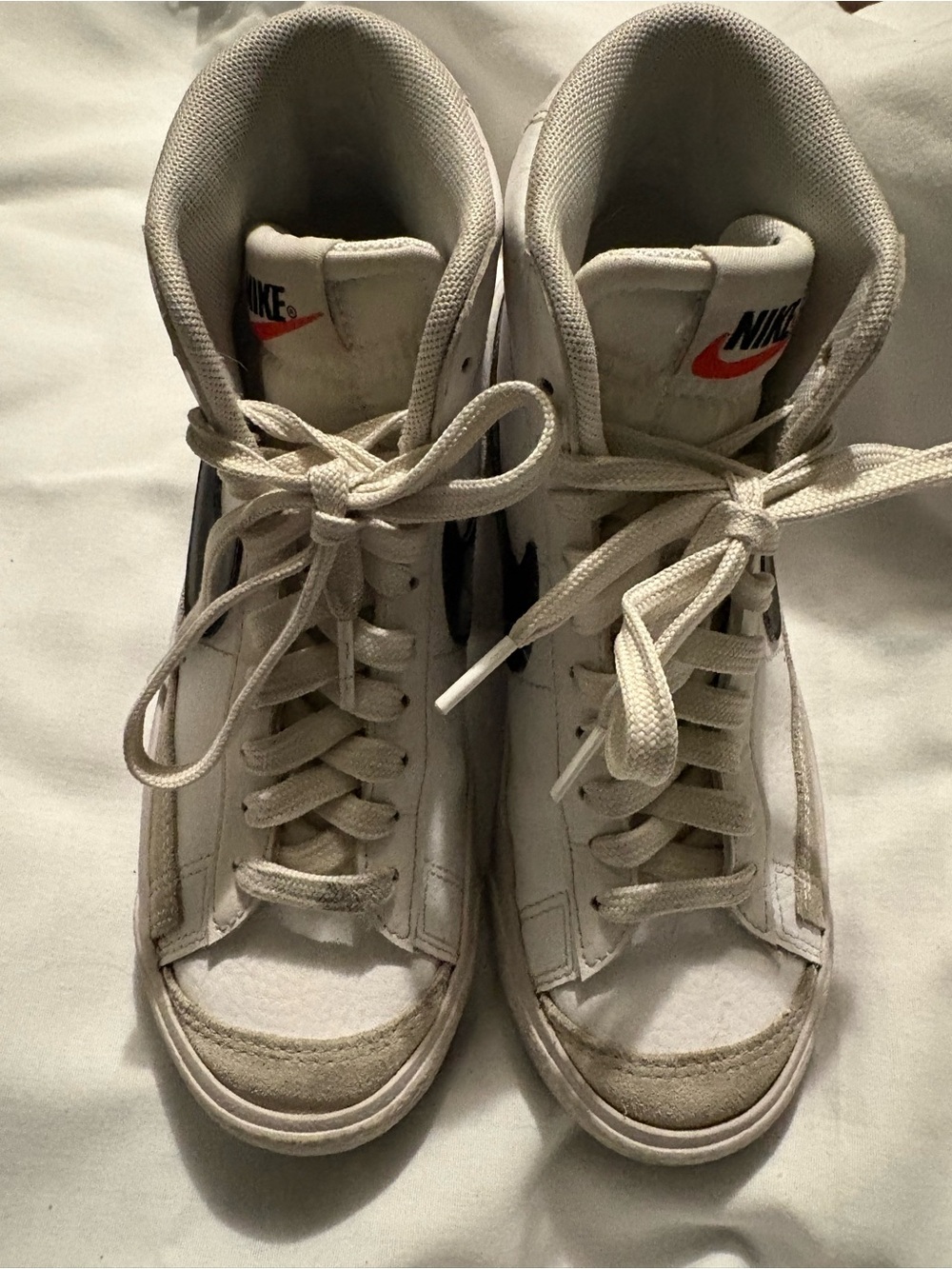 Nike White High-Top Sneakers with Black Swoosh and Red Tongue Logo